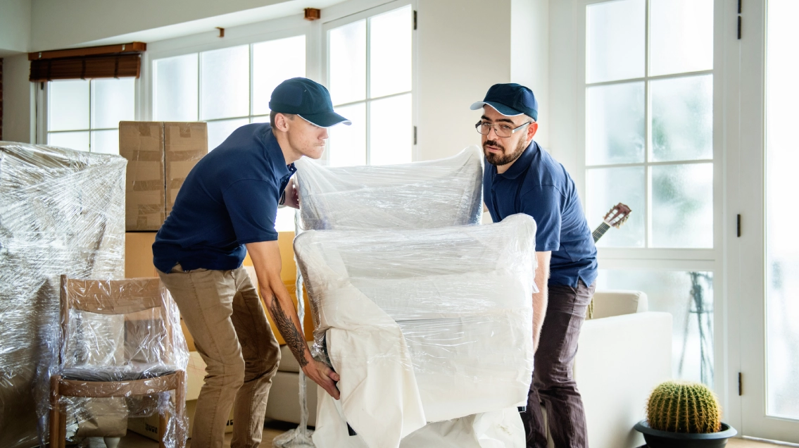Workers organizing boxes inside a unit for professional storage services.